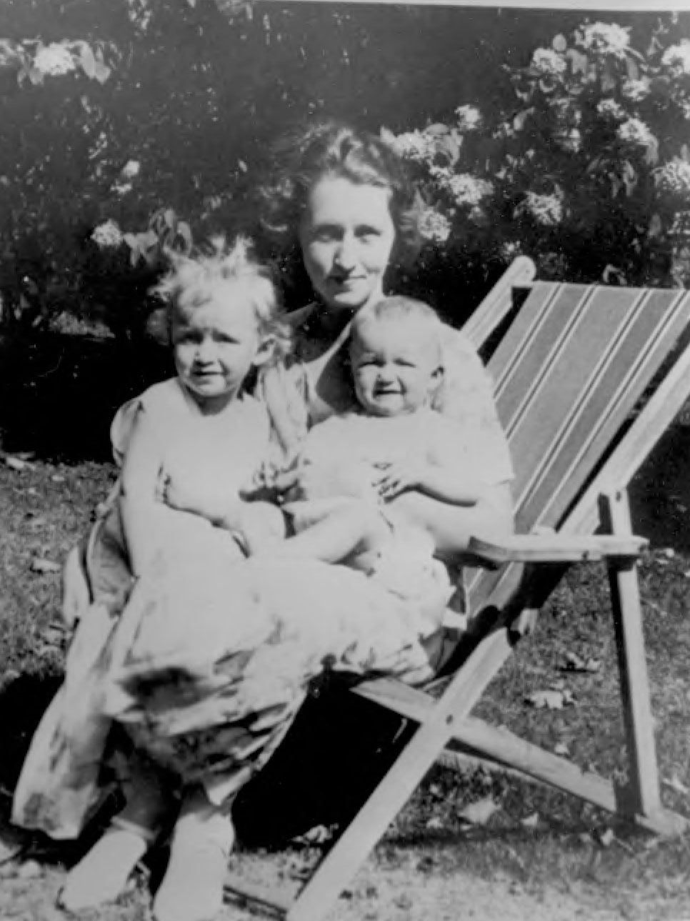 Black and white image of woman holding two children