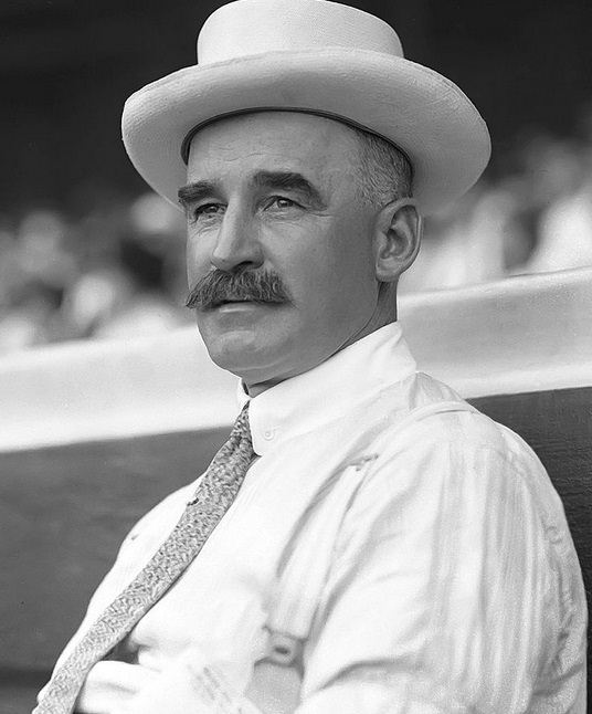 Black and white image of man in hat