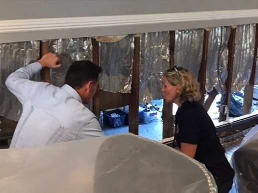 (County Executive Curran and Congressman Suozzi inspect a damaged home)